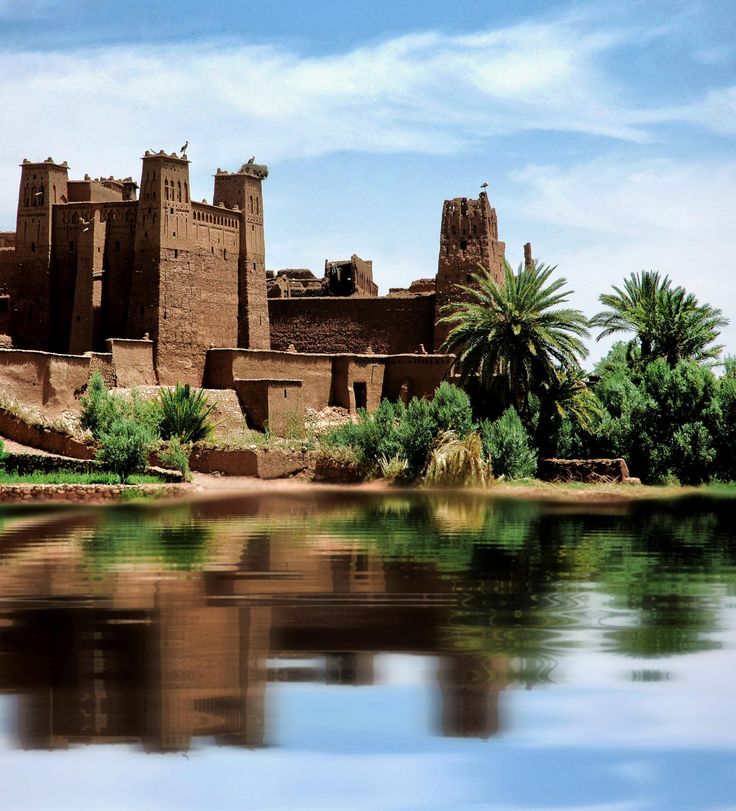 Earthen kasbah towers above the river, palms and gardens of the Ounila